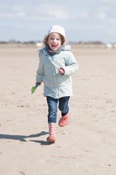 Toddler running on the beach