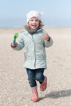 Toddler running on the beach
