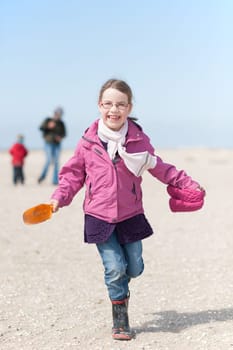 Toddler running on the beach