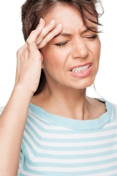 Young woman in front of white background with headache