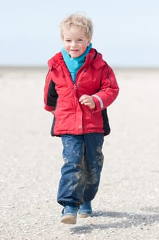 Toddler running on the beach