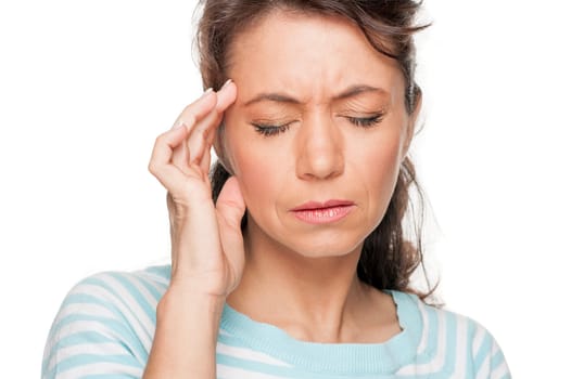 Young woman in front of white background with headache