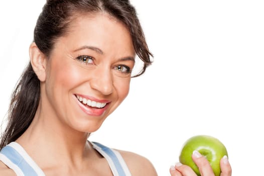 Smiling woman in front of white background with a green apple