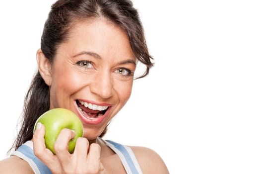 Smiling woman in front of white background with a green apple