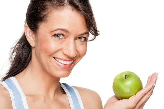 Smiling woman in front of white background with a green apple