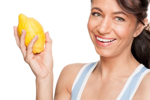 Smiling woman in front of white background with lemon