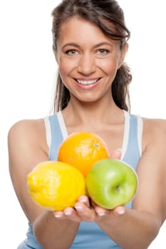 Smiling woman in front of white background with fruit
