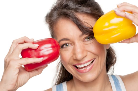 Smiling woman in front of white background with peppers