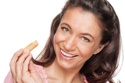 Smiling woman with a biscuit against a white background