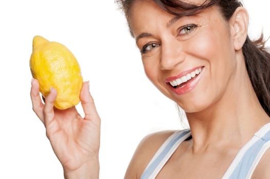 Smiling woman in front of white background with lemon