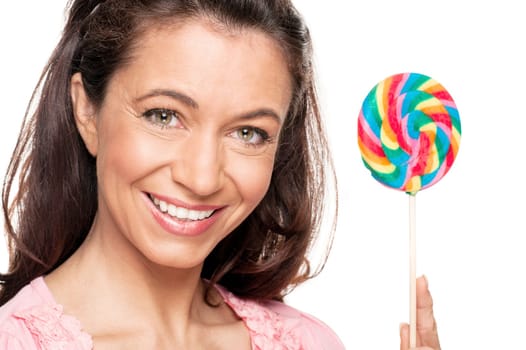 Smiling woman with a lollipop against a white background
