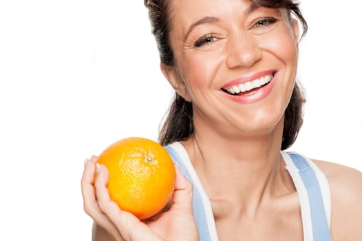Smiling woman in front of white background with an orange