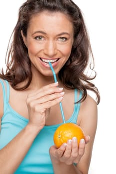 Smiling woman with a straw and an orange