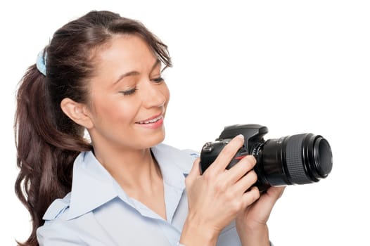 Smiling woman with a camera against a white background