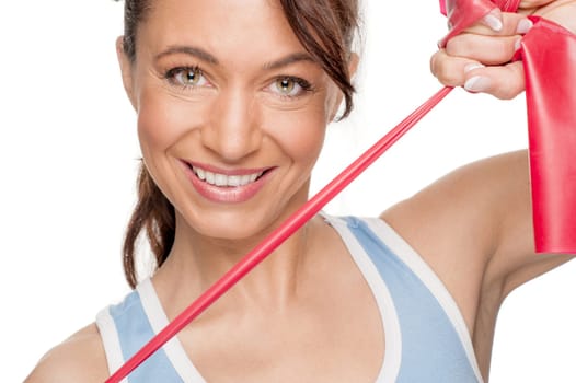 Sporty woman with a red gymnastics ribbon in front of a white background