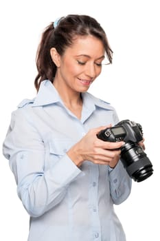 Smiling woman with a camera against a white background