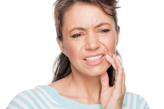 Young woman in front of white background with toothache