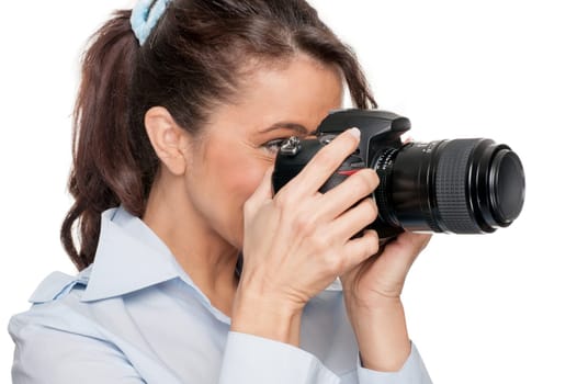 Smiling woman with a camera against a white background
