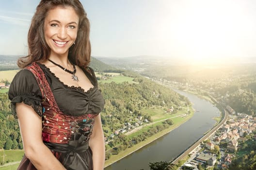 Smiling woman in front of the panorama of the Elbe Sandstone Mountains