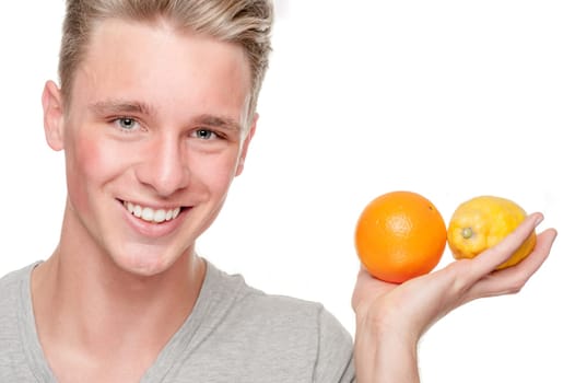 Young and smiling man with lemon and orange