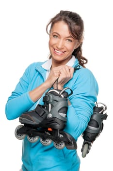 Sporty woman with inline skates in front of white background
