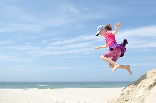 Toddler jumping in front of blue sky