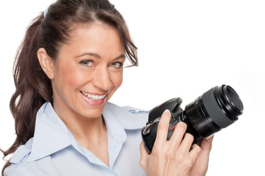 Smiling woman with a camera against a white background