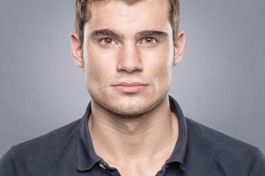 Portrait of a young man against a blue background
