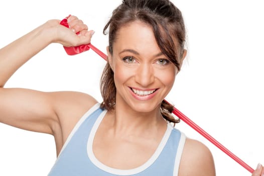 Sporty woman with a red gymnastics ribbon in front of a white background