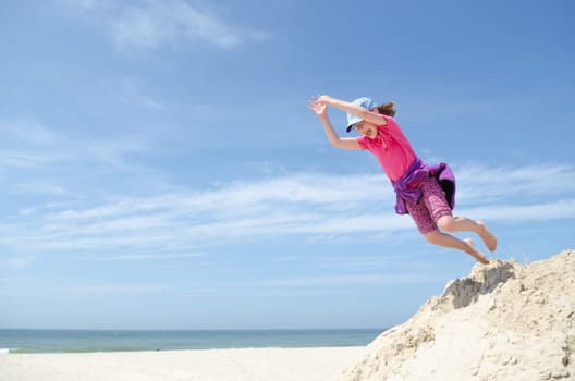 Toddler jumping in front of blue sky
