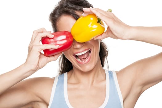 Smiling woman in front of white background with peppers