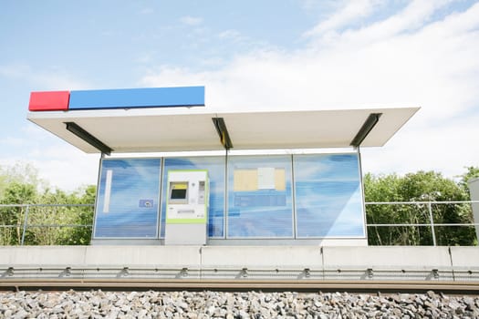 Two blue billboards at a train stop