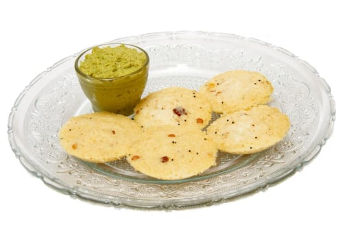 Dish of delicious, mouth-watering "Rice Rave Idli"" and coconut ""Chatni"" isolated on white"