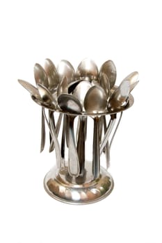 Stand holding stainless steel spoons neatly, isolate on white