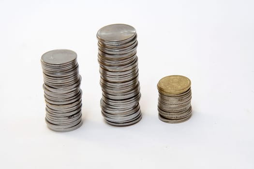 Columns of coins indicating trends in financial market, isolated on white