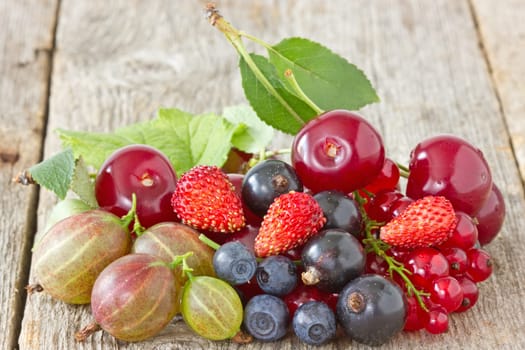 pile of assorted berries on the wooden floor