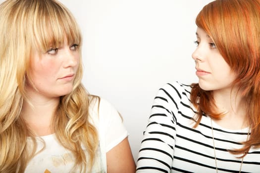 blond and red haired girl are upset and disappointed