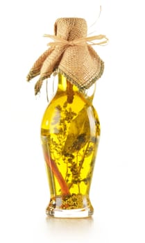 Bottle of traditionaly made extra virgin olive oil with aromatic herbs isolated on white