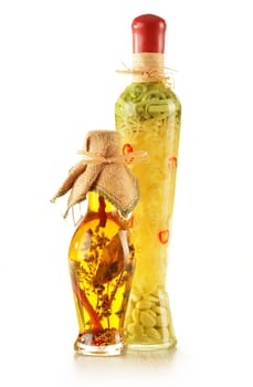 Bottle of traditionaly made extra virgin olive oil with aromatic herbs isolated on white