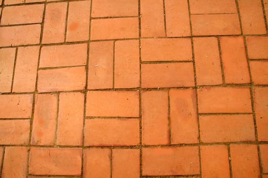 Walkway with neatly laid reddish brown bricks
