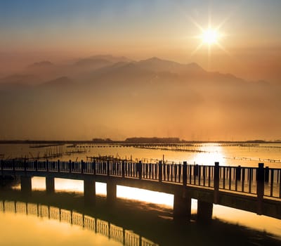 Sea stones at sunset with nice bridge