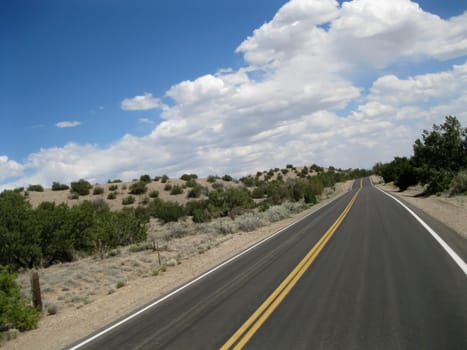 Paved road in the desert from an oblique perspective