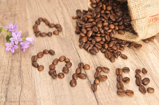 Grains of coffee on a wooden surface