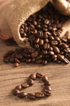 Grains of coffee on a wooden surface