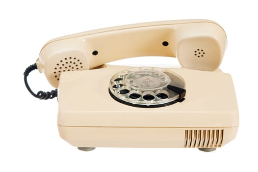 Old analog phone with a disk, it is isolated on white