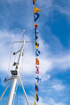 Mast with the navigating equipment of a yacht and alarm flags