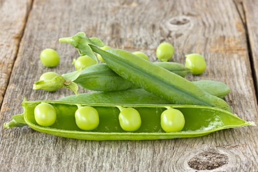 green organic peas on the  wooden background