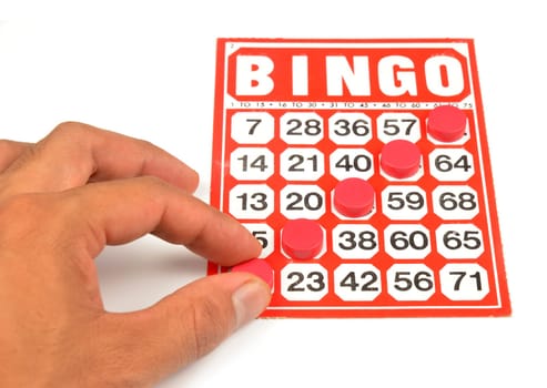 bingo card with hand hold winning chips