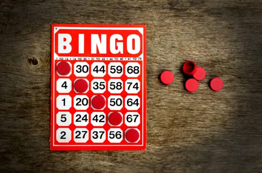 Red bingo card with winning chips