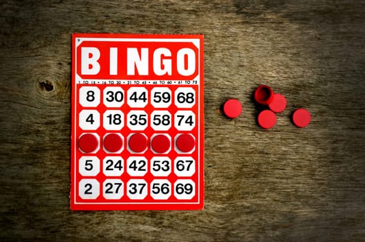 Red bingo card with winning chips